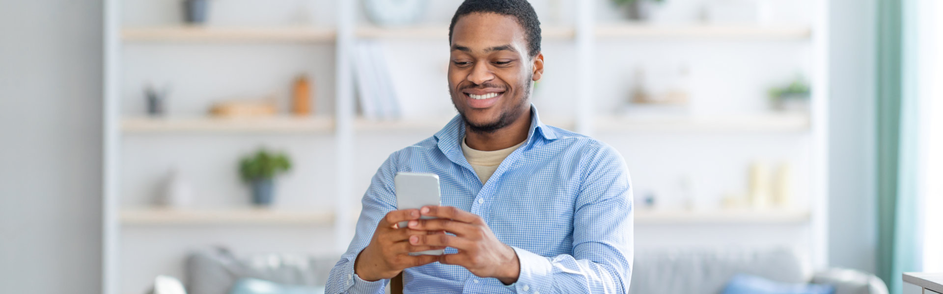 smiling man holding a phone